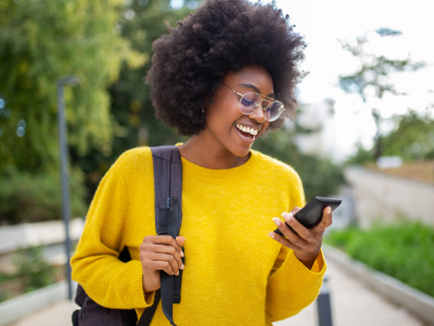 Woman smiling at smartphone